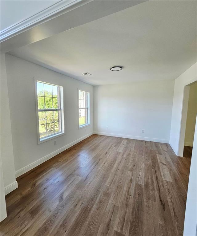 681 Burtons Cv, Hampton, GA 30228 - spare room featuring wood finished floors and baseboards