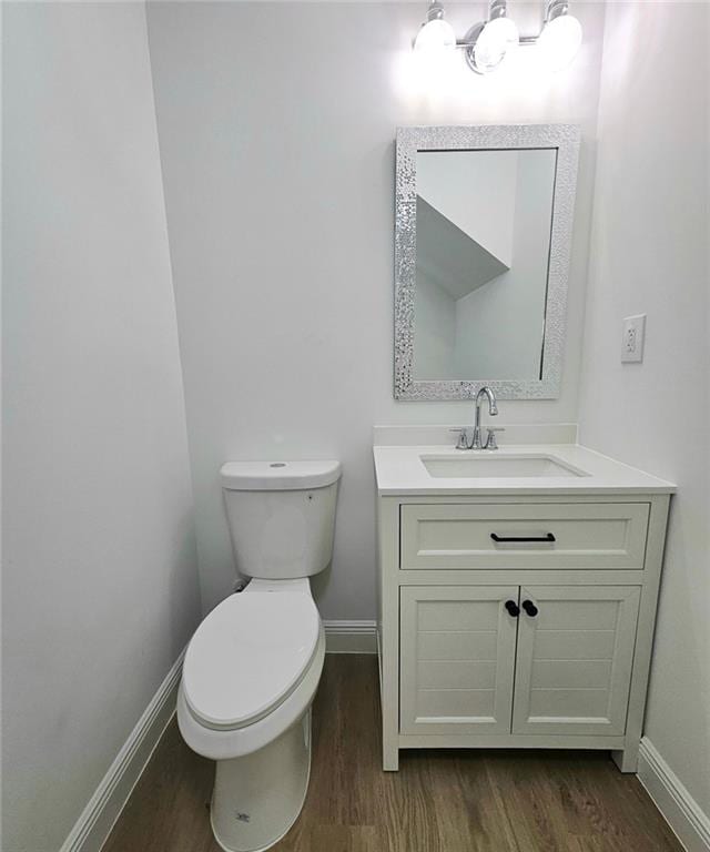 681 Burtons Cv, Hampton, GA 30228 - half bathroom with wood finished floors, baseboards, and toilet