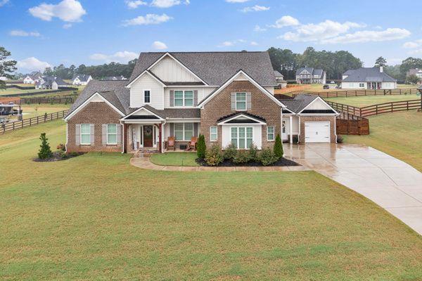 craftsman-style home with a front lawn and a garage