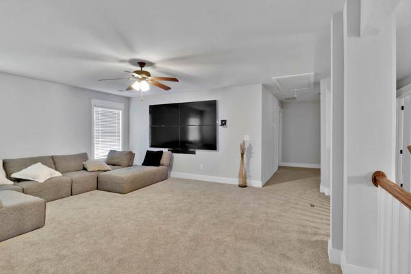 additional living space featuring carpet and vaulted ceiling