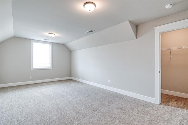 additional living space featuring carpet floors and lofted ceiling