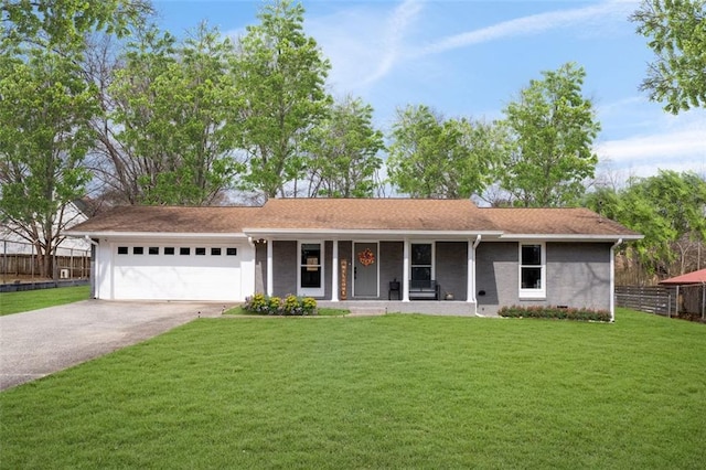 view of front of property with a porch, a front yard, fence, a garage, and driveway