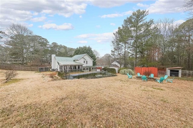 view of yard featuring an outbuilding and fence