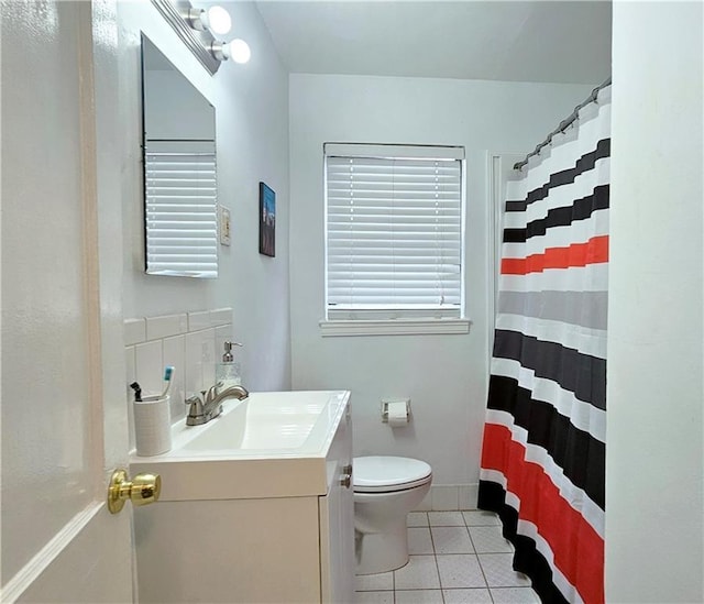 bathroom featuring tile patterned flooring, vanity, curtained shower, and toilet