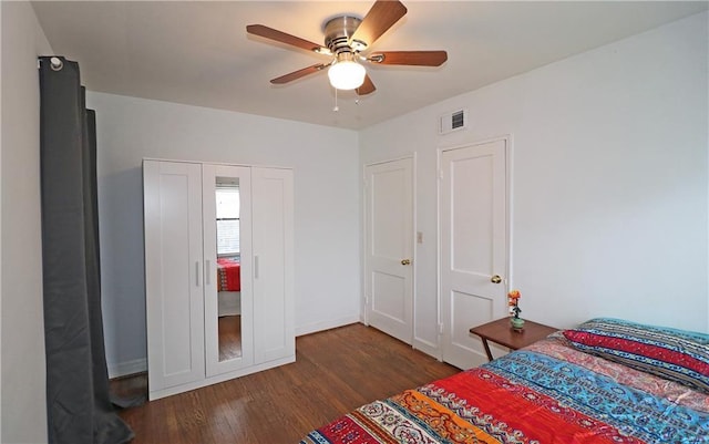 bedroom with ceiling fan and dark hardwood / wood-style floors