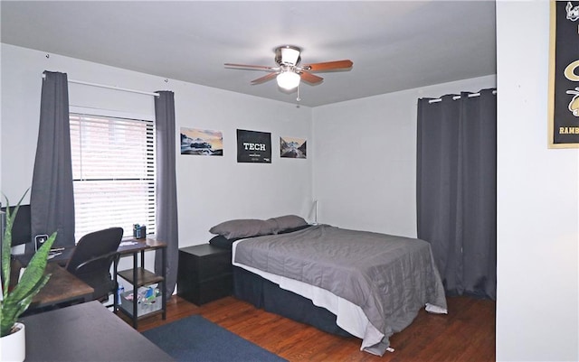 bedroom with dark hardwood / wood-style flooring and ceiling fan