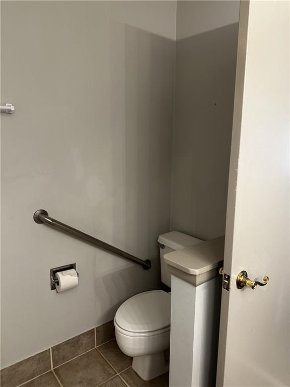 bathroom with tile patterned floors and toilet