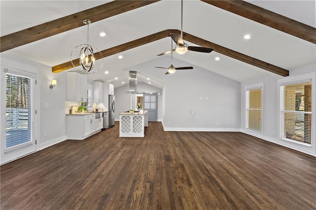 unfurnished living room with vaulted ceiling with beams, dark wood-style floors, baseboards, and a wealth of natural light