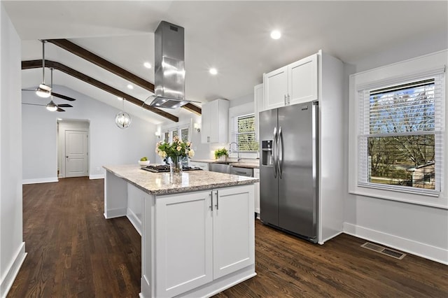 kitchen featuring island range hood, visible vents, lofted ceiling with beams, appliances with stainless steel finishes, and a center island