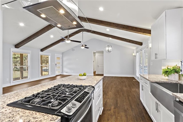 kitchen featuring light stone countertops, open floor plan, lofted ceiling with beams, range with gas stovetop, and white cabinetry