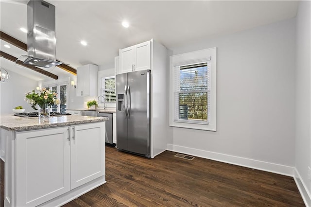 kitchen with visible vents, white cabinetry, stainless steel appliances, island range hood, and dark wood-style flooring