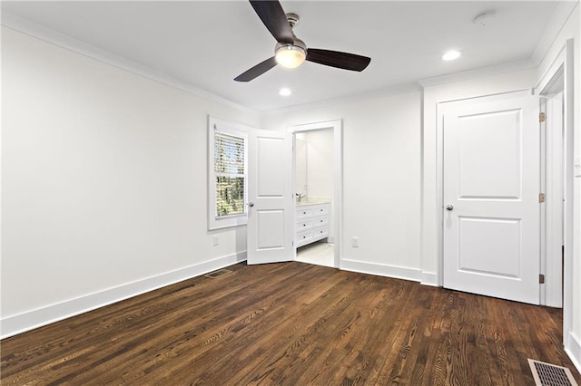 unfurnished bedroom with visible vents, baseboards, dark wood-style floors, and ornamental molding