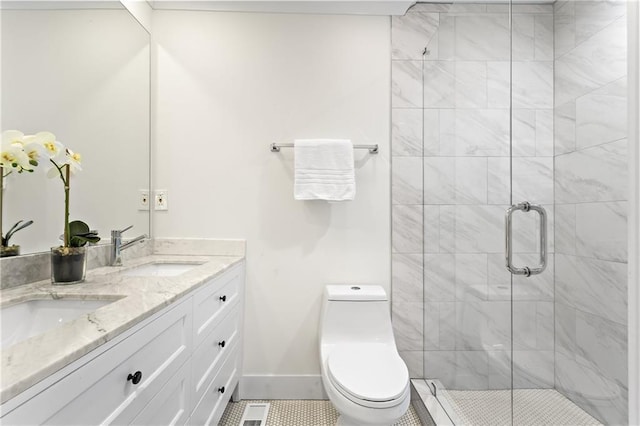 bathroom with double vanity, toilet, a stall shower, and a sink