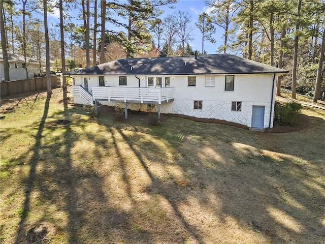 back of house featuring brick siding and a deck