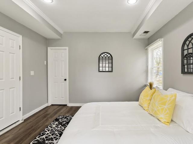 bedroom featuring visible vents, baseboards, and dark wood-style floors