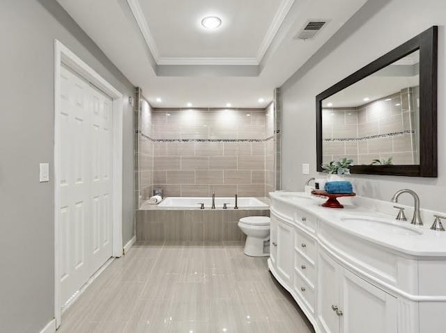 bathroom featuring visible vents, a sink, a relaxing tiled tub, crown molding, and a raised ceiling