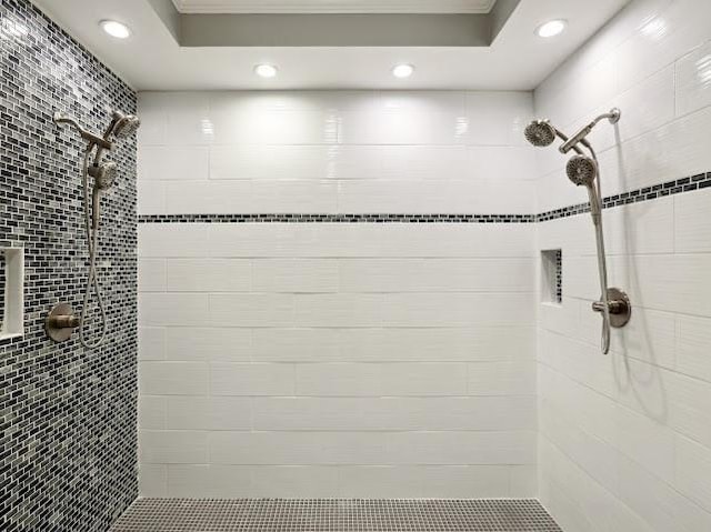 full bathroom with a tile shower and recessed lighting