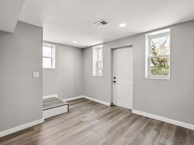 entryway featuring visible vents, recessed lighting, baseboards, and wood finished floors