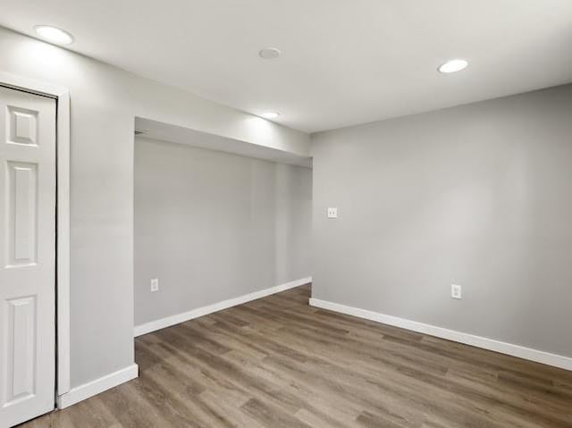 finished below grade area with recessed lighting, baseboards, and wood finished floors