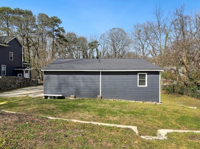 view of side of home with a lawn