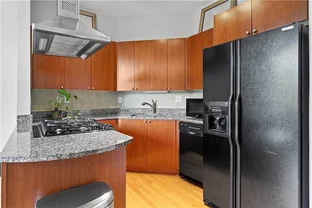 2626 Peachtree Rd NW Unit 606, Atlanta, GA 30305 - kitchen with island range hood, visible vents, light wood-type flooring, and black appliances