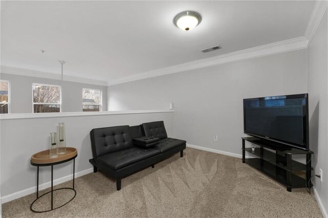 living area with crown molding and light colored carpet