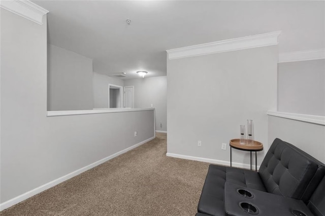 sitting room featuring ornamental molding and carpet flooring