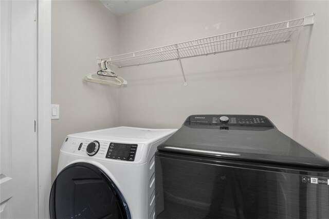 washroom with separate washer and dryer