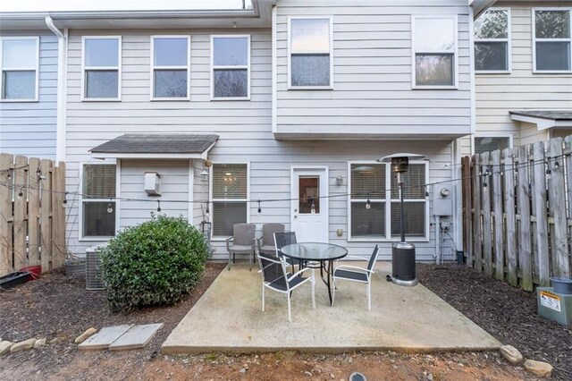 rear view of property featuring central AC and a patio area