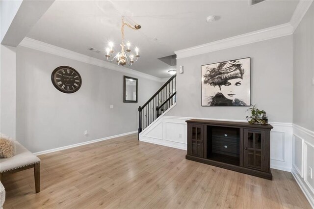 interior space featuring a notable chandelier, crown molding, and light hardwood / wood-style floors