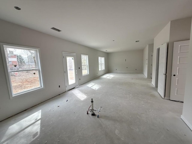 unfurnished living room with visible vents