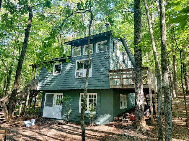 back of house with a deck and stairs