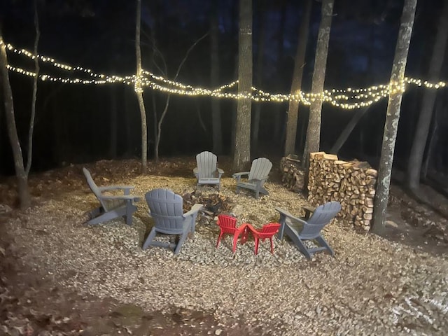 yard at night featuring an outdoor fire pit
