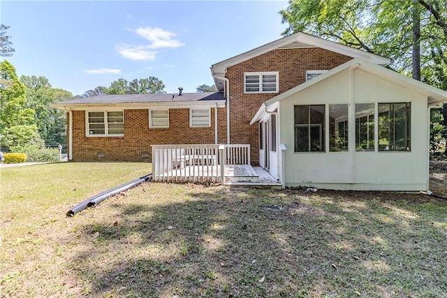 738 Laverne Dr NW, Atlanta, GA 30318 - back of house featuring a sunroom, a wooden deck, a yard, and brick siding