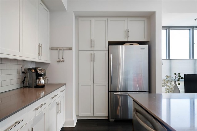 1100 Howell Mill Rd NW Unit 708, Atlanta, GA 30318 - kitchen with freestanding refrigerator, tasteful backsplash, white cabinetry, and dark wood-style flooring