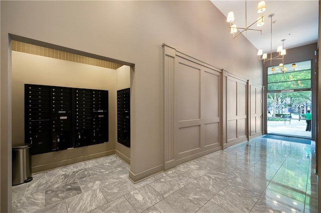1100 Howell Mill Rd NW Unit 708, Atlanta, GA 30318 - view of community with a high ceiling, a decorative wall, a chandelier, and mail area
