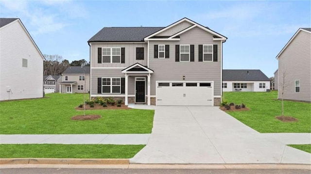 view of front of house with a front lawn, an attached garage, stone siding, and driveway