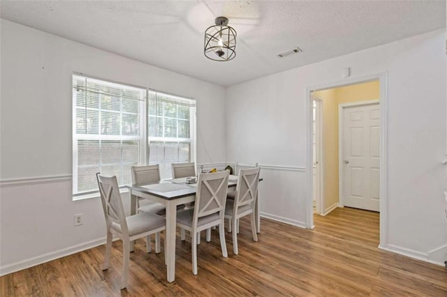 1450 Steam Engine Way, Conyers, GA 30013 - dining area with wood finished floors, baseboards, and a textured ceiling