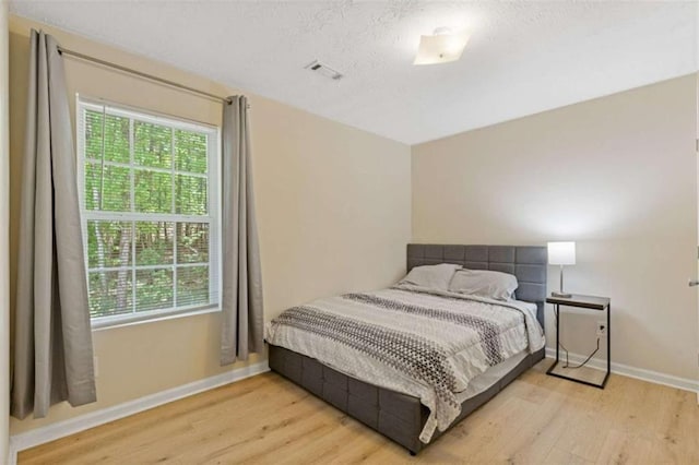 1450 Steam Engine Way, Conyers, GA 30013 - bedroom featuring wood finished floors, multiple windows, and baseboards