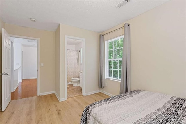 1450 Steam Engine Way, Conyers, GA 30013 - bedroom with light wood-style floors, baseboards, and ensuite bathroom