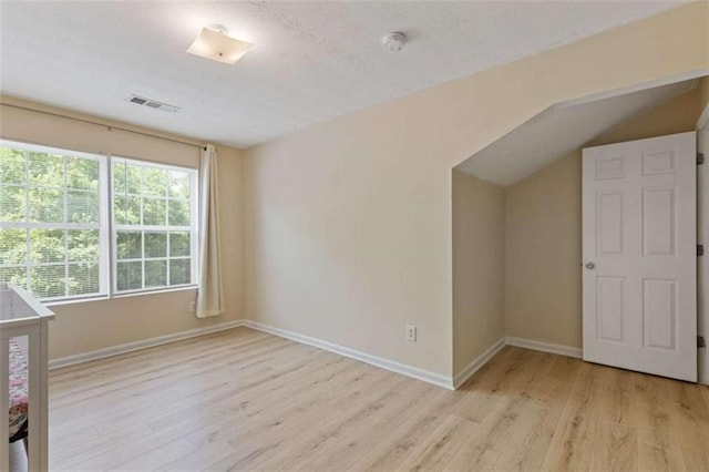 1450 Steam Engine Way, Conyers, GA 30013 - unfurnished bedroom featuring light wood-style floors, baseboards, and vaulted ceiling