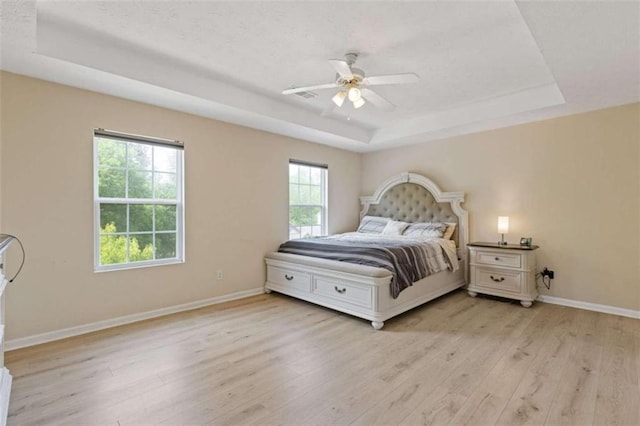 1450 Steam Engine Way, Conyers, GA 30013 - bedroom with a tray ceiling, light wood-type flooring, baseboards, and a ceiling fan