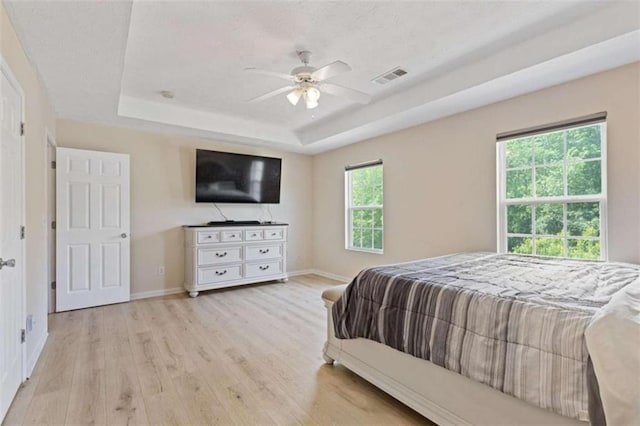 1450 Steam Engine Way, Conyers, GA 30013 - bedroom featuring a raised ceiling, light wood-style floors, baseboards, and ceiling fan