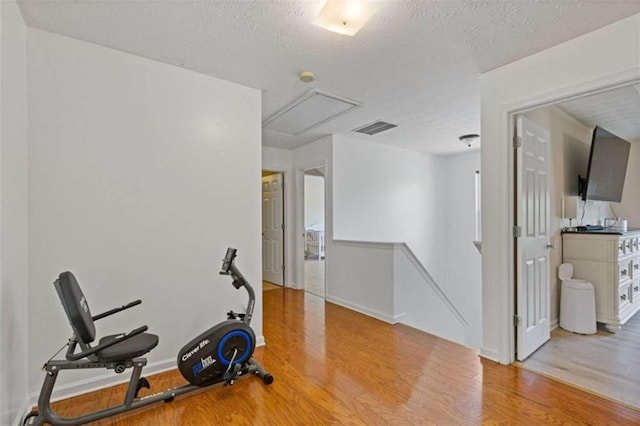 1450 Steam Engine Way, Conyers, GA 30013 - workout room featuring attic access, wood finished floors, a textured ceiling, and baseboards