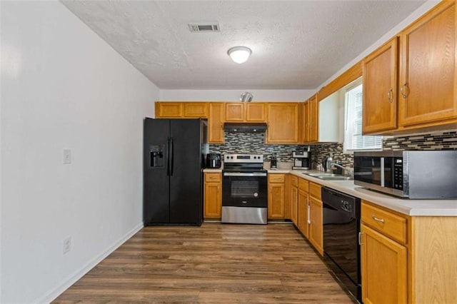 1450 Steam Engine Way, Conyers, GA 30013 - kitchen featuring black appliances, under cabinet range hood, a sink, backsplash, and a textured ceiling