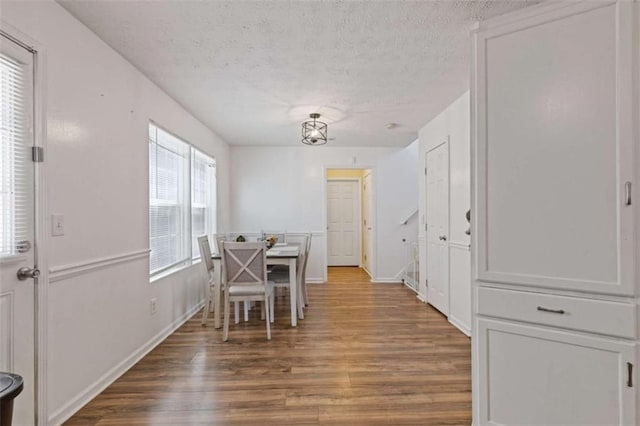 1450 Steam Engine Way, Conyers, GA 30013 - dining room featuring wood finished floors, a textured ceiling, and baseboards
