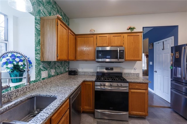 kitchen featuring appliances with stainless steel finishes and light stone countertops