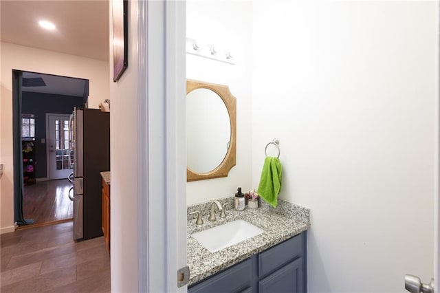 bathroom with vanity and hardwood / wood-style floors