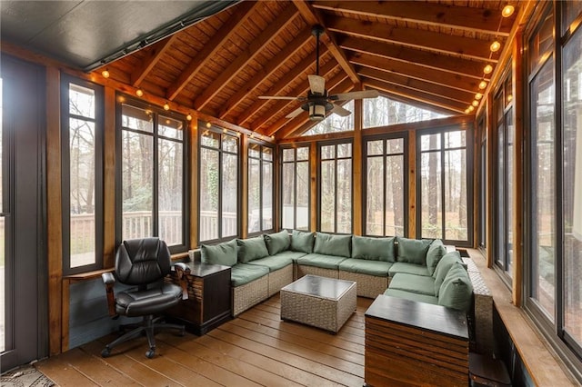 sunroom featuring wooden ceiling, vaulted ceiling with beams, and a healthy amount of sunlight