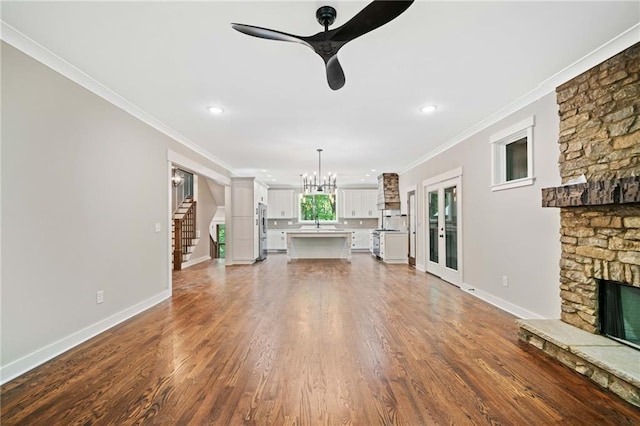 4189 Tamarack Dr, Jasper, GA 30143 - unfurnished living room featuring a fireplace, ornamental molding, a chandelier, ceiling fan, and wood finished floors
